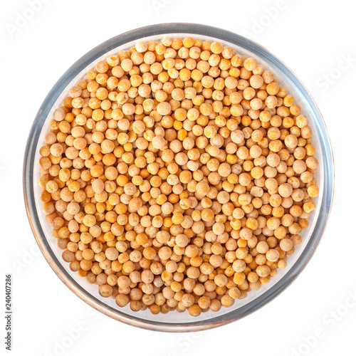 Seeds of peas on glass bowl on white background