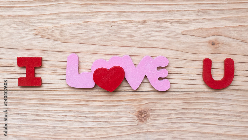 I Love U text on wooden table background. romantic and Valentine Day holiday Concept I Love U text on wooden table background. romantic and Valentine Day holiday Concept
