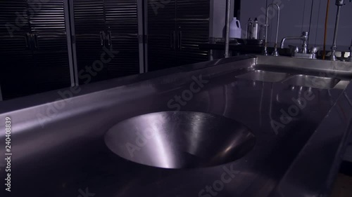 EMPTY AUTOPSY TABLE SLIDER SHOT IN 4K, 10 BIT, 4:2:2. photo