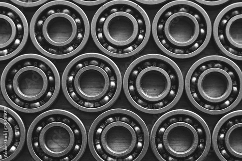 Machinery concept. Set of various gears and ball bearings old and new  BW  black and white  texture background