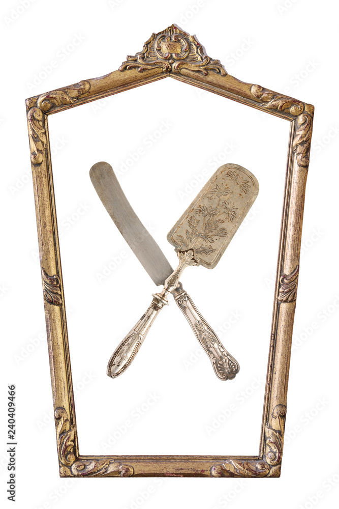 Fototapeta premium Vintage gilded pentagonal frame and crossed cake shovel and knife with an ornament isolated on white. Retro style.