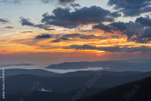 Beautiful sunrise in the Skole Beskydy with fantastic beauty over the sky, and the fog sea around the majestic Carpathian Mountains. © reme80