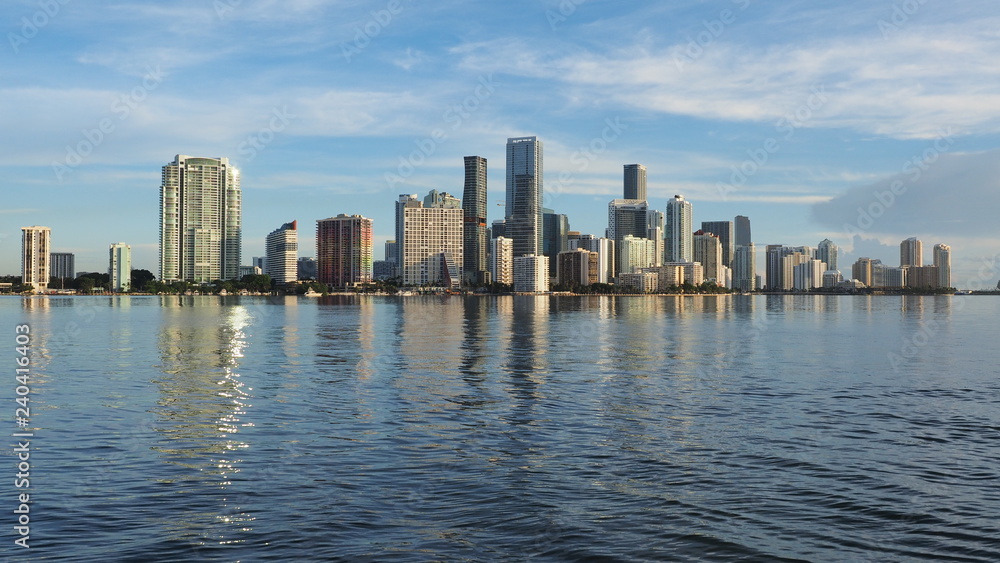 Miami, Florida 09-08-2018 City of Miami skyline and its reflection on the tranquil water of Biscayne Bay. Miami, Florida 09-08-2018 City of Miami skyline and its reflection on the tranquil water of Biscayne Bay.