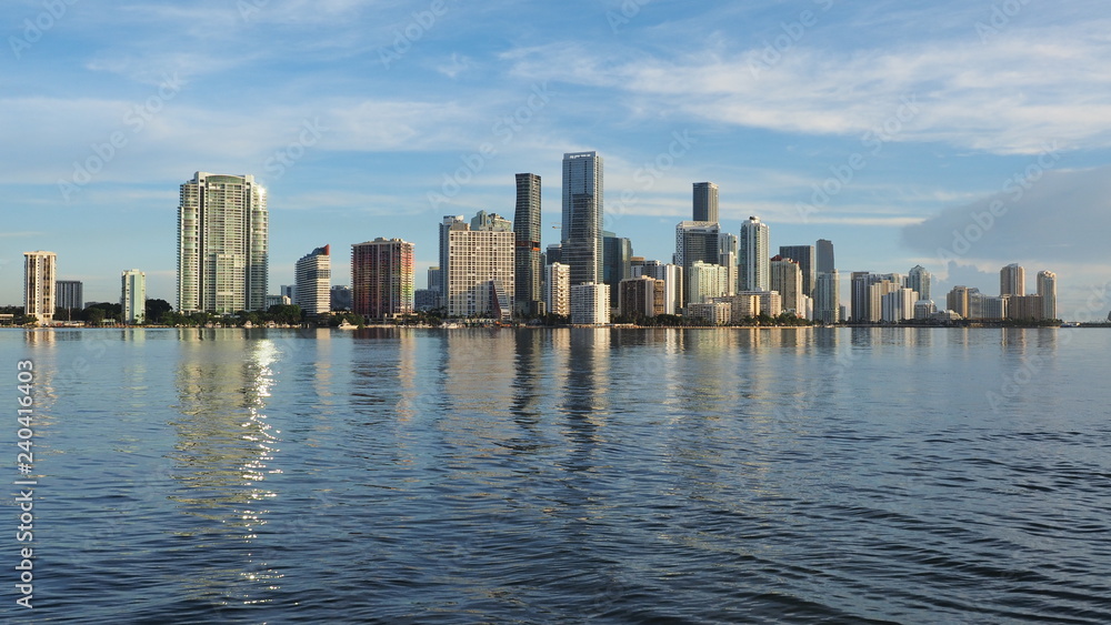 Miami, Florida 09-08-2018 City of Miami skyline and its reflection on the tranquil water of Biscayne Bay.