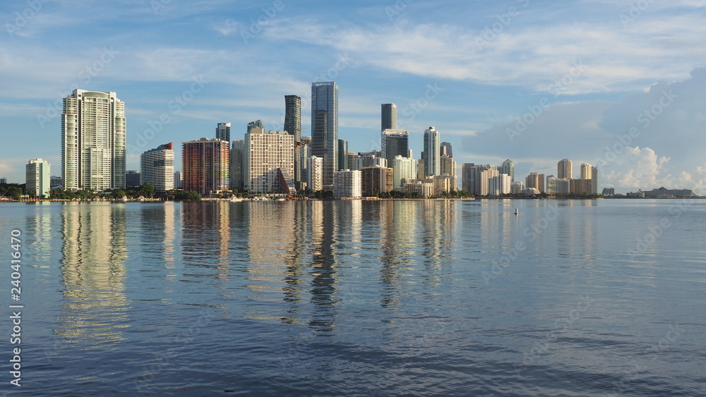 Miami, Florida 09-08-2018 City of Miami skyline and its reflection on the tranquil water of Biscayne Bay.