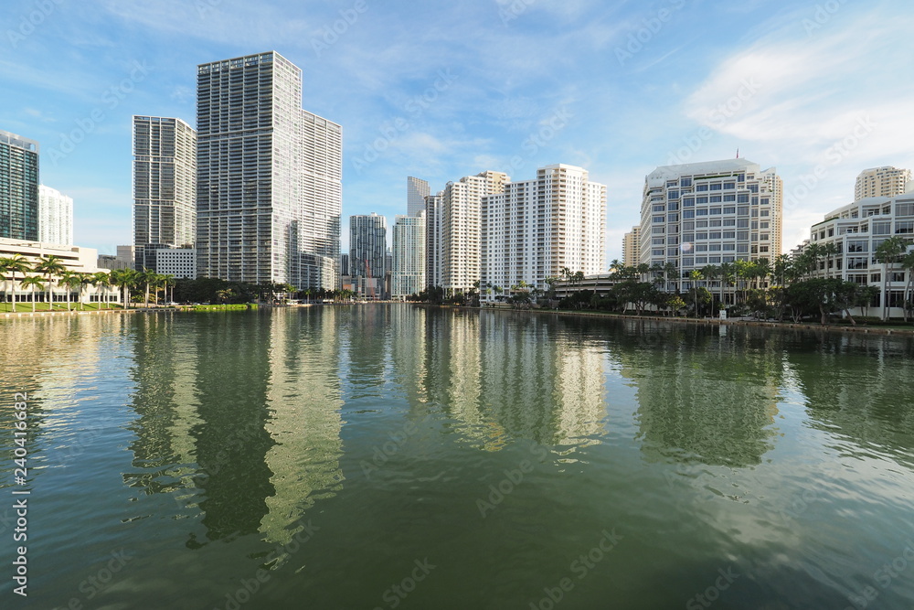 Miami, Florida 09-08-2018 Buildings of the City of Miami and Brickell Key and their reflections on the tranquil water of Biscayne Bay.