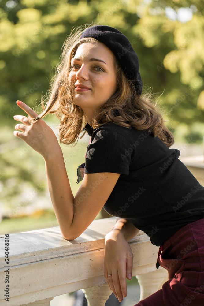 Fototapeta premium The girl in beret and skirt in the park 