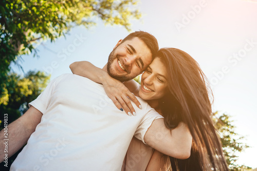 Young couple walking in the summer park. © teksomolika