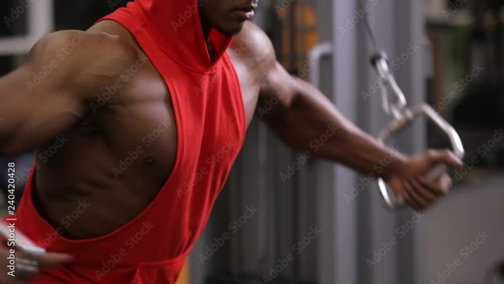 African american man making exercice on training apparatus in gym