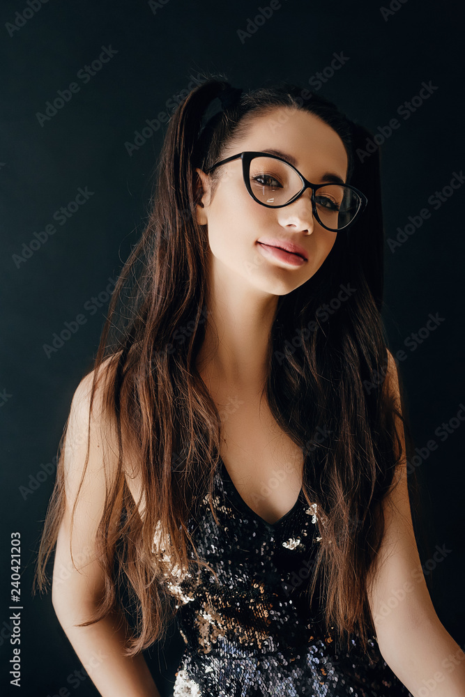 Portrait of beautiful brunette girl with makeup in glasses Portrait of beautiful brunette girl with makeup in glasses
