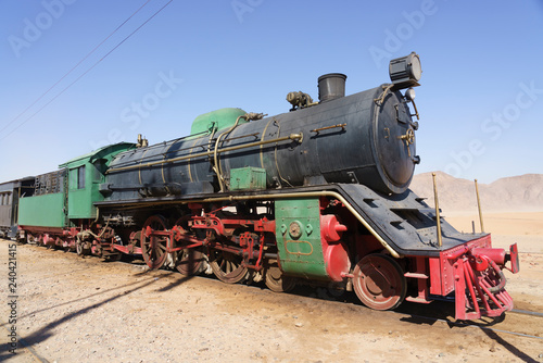 Steam train on a tracks in the desert