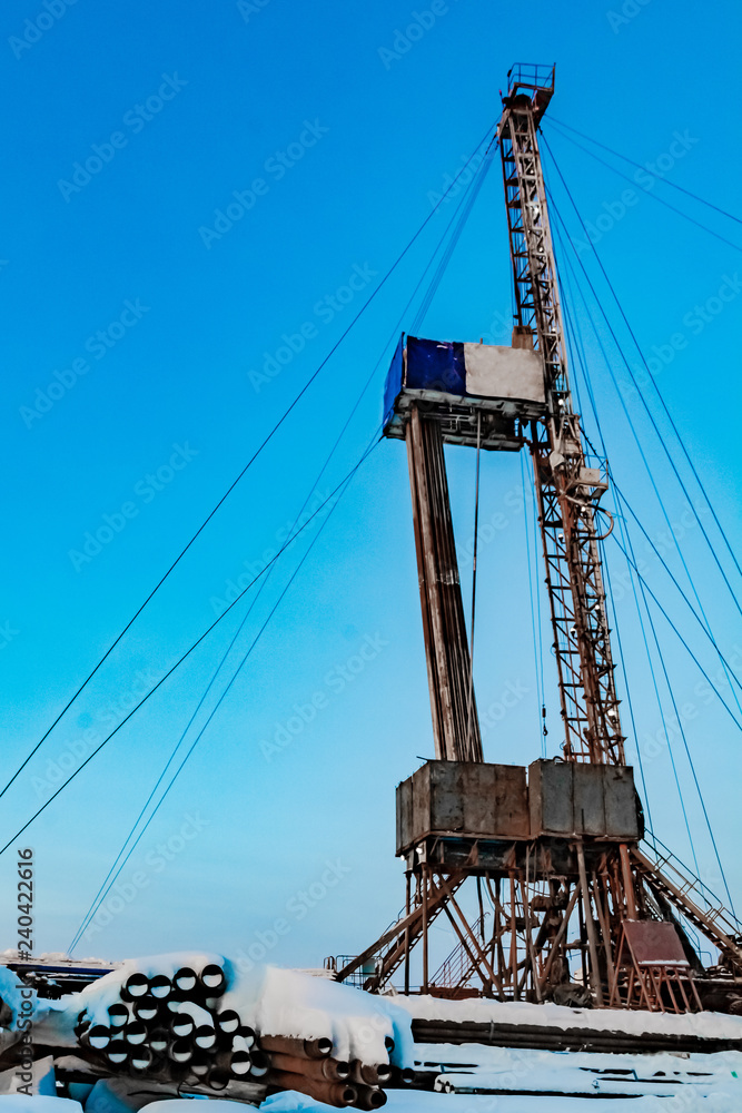 Drilling a deep well with a drilling rig at an oil and gas field. The deposit is located in the Far North beyond the Arctic Circle. The shooting was conducted in the winter during the polar day