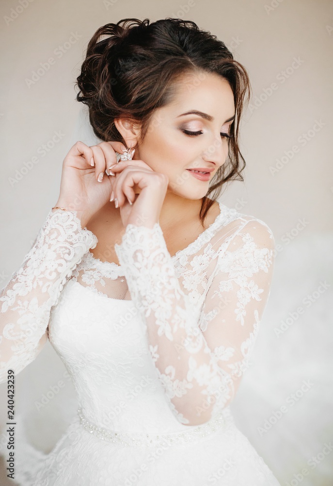 Beautiful brunette bride with stylish make-up in white dress Beautiful brunette bride with stylish make-up in white dress