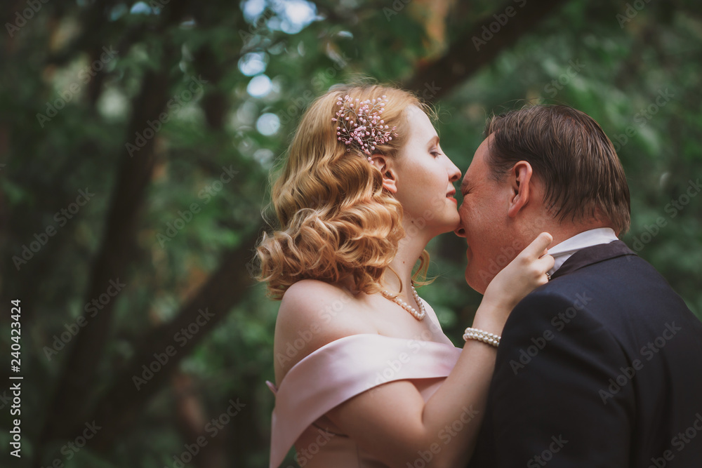bride and groom kissing in the summer forest bride and groom kissing in the summer forest