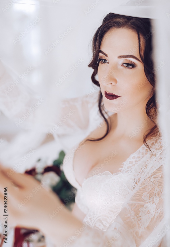 Morning of fiancee.Portrait of beautiful young woman in white peignoir Morning of fiancee.Portrait of beautiful young woman in white peignoir