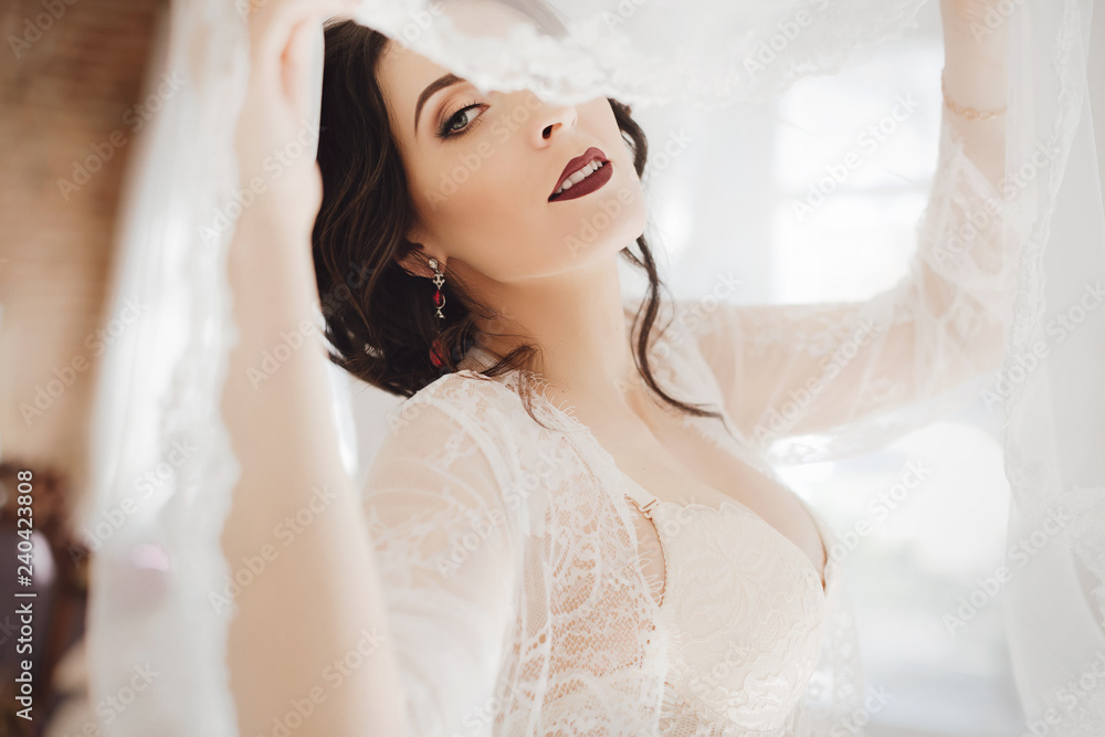 Morning of fiancee.Portrait of beautiful young woman in white peignoir Morning of fiancee.Portrait of beautiful young woman in white peignoir
