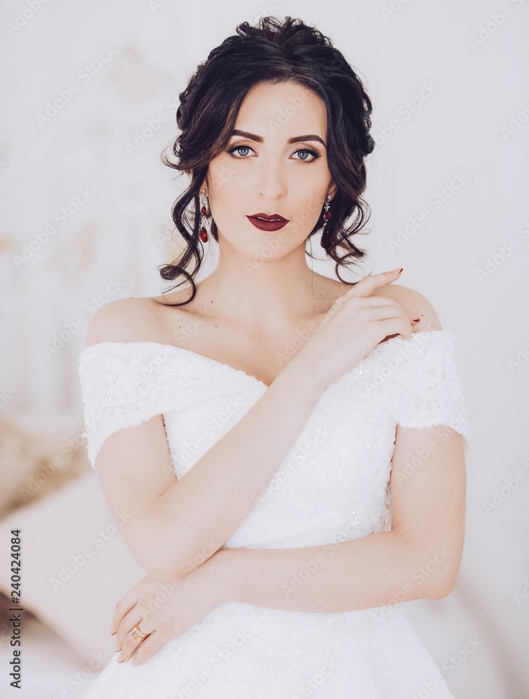 Beautiful brunette bride with stylish make-up in white dress Beautiful brunette bride with stylish make-up in white dress