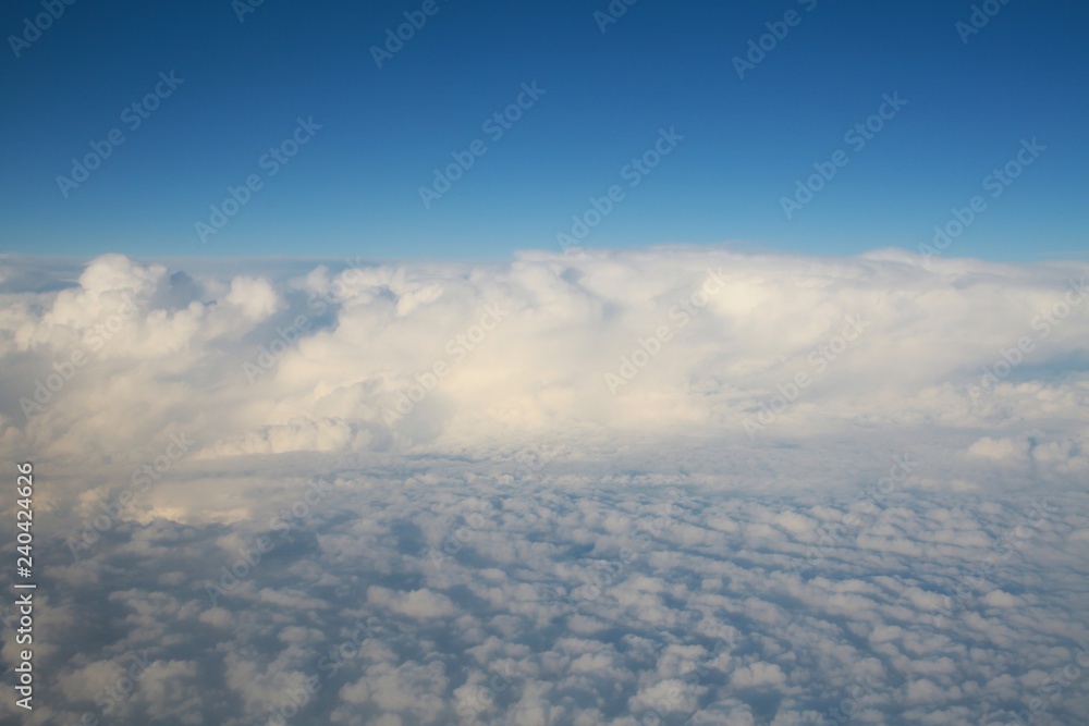 Looking Out the Window of a Commercial Jet Down on a Bank of Enormous White Fluffy Clouds Heading North Up the East Coast of the United States toward Washington D.C. Late in the Afternoon Looking Out the Window of a Commercial Jet Down on a Bank of Enormous White Fluffy Clouds Heading North Up the East Coast of the United States toward Washington D.C. Late in the Afternoon