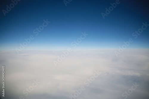 Looking Out the Window of a Commercial Jet Down on a Bank of Enormous White Fluffy Clouds Heading North Up the East Coast of the United States toward Washington D.C. Late in the Afternoon