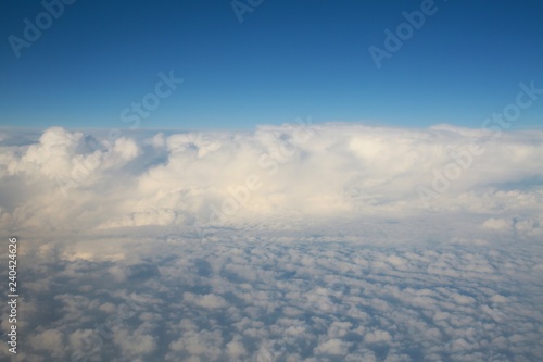 Looking Out the Window of a Commercial Jet Down on a Bank of Enormous White Fluffy Clouds Heading North Up the East Coast of the United States toward Washington D.C. Late in the Afternoon