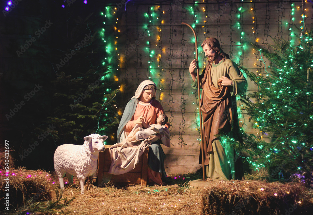 Christmas Manger scene with figures including Jesus, Mary, Joseph, sheep and magi. Soft focus Christmas Manger scene with figures including Jesus, Mary, Joseph, sheep and magi. Soft focus