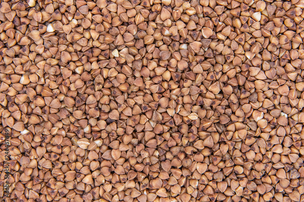 Dark Buckwheat Texture. Background Buckwheat Groats Close-up. Dark Buckwheat Texture. Background Buckwheat Groats Close-up.
