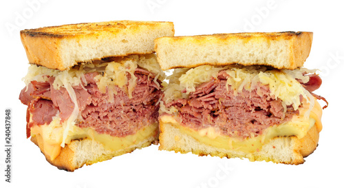 Pastrami Reuben style sandwiches with sauerkraut and melted Swiss cheese isolated on a white background photo
