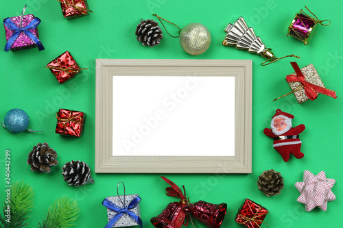 Christmas decoration equipment and photo frame on green paper art background.