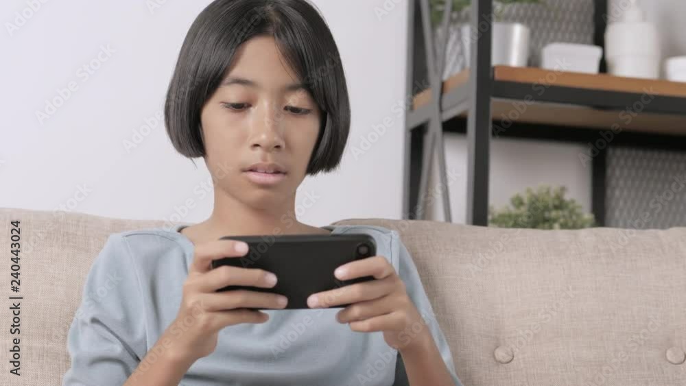 Asian girl are using a smartphone to play game. Asian girl are using a smartphone to play game.