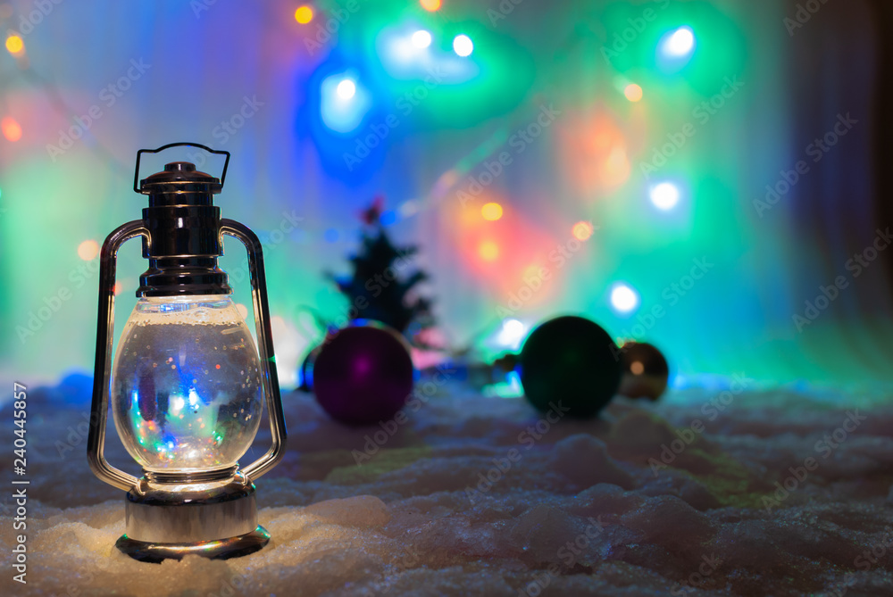 Christmas photo with a lamp and blurry garland and Christmas tree toys on the background.new year card Christmas photo with a lamp and blurry garland and Christmas tree toys on the background.new year card