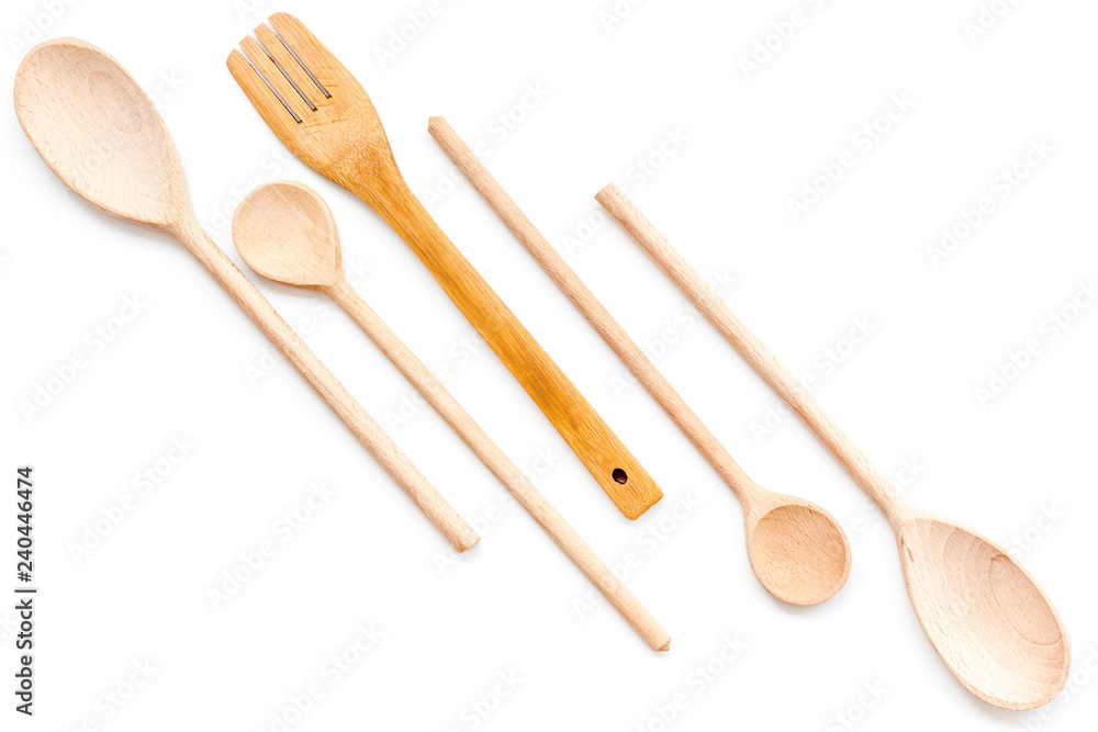 Woodenware set with spoons and forks on white background top view Woodenware set with spoons and forks on white background top view