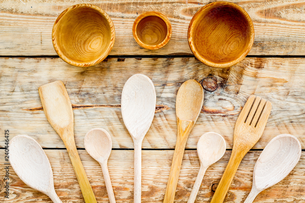 Village wooden cutlery set on wooden background top view Village wooden cutlery set on wooden background top view