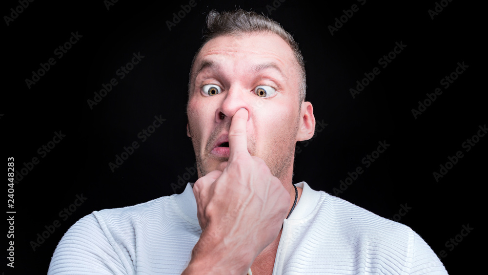 Man putting finger deep in his nose. Bad habit concept Man putting finger deep in his nose. Bad habit concept