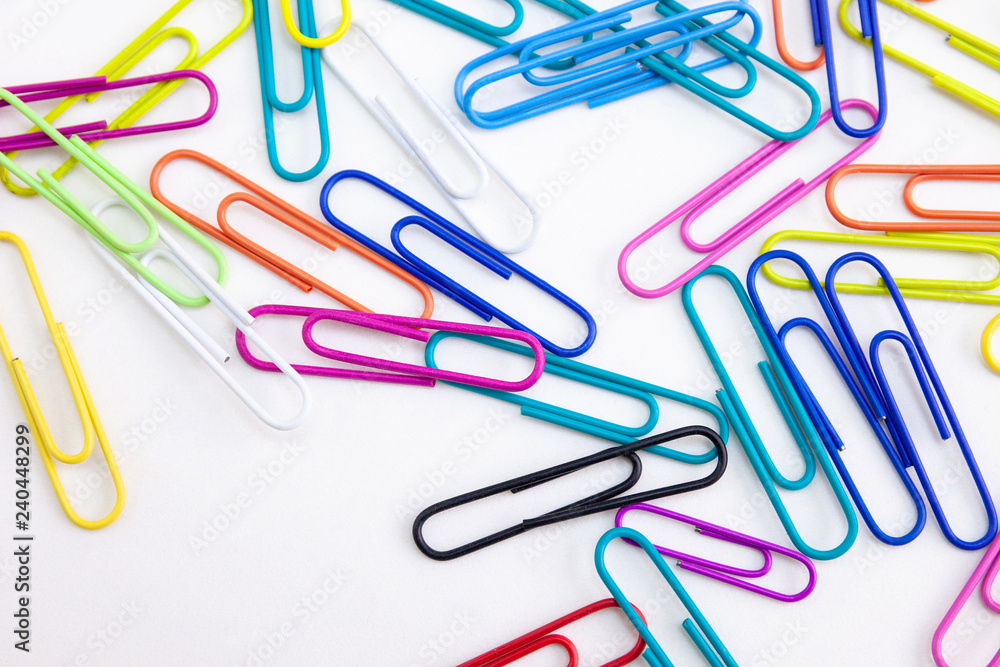 Multi-colored paper clips on white background, Closeup. Abstract. Multi-colored paper clips on white background, Closeup. Abstract.