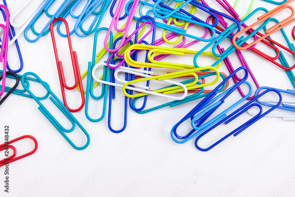 Wire colorful paperclips stack on white background, Concepts of equipments office supplies, Closeup, Top view. Wire colorful paperclips stack on white background, Concepts of equipments office supplies, Closeup, Top view.