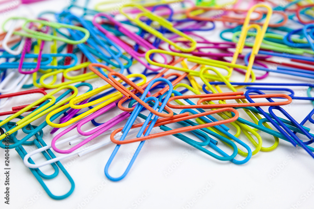 Close-up a lot of variety color of paper clips on white background, Office supplies concepts. Close-up a lot of variety color of paper clips on white background, Office supplies concepts.
