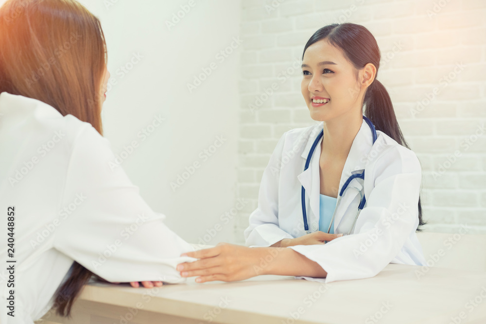 Female doctor talking to patient.Doctor and patient discussing something while sitting at the table . Medicine and health care concept. Doctor and patient Female doctor talking to patient.Doctor and patient discussing something while sitting at the table . Medicine and health care concept. Doctor and patient