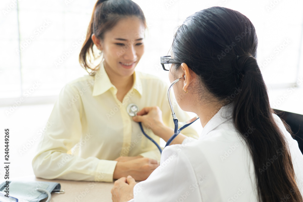 Female doctor talking to patient.Doctor and patient discussing something while sitting at the table . Medicine and health care concept. Doctor and patient Female doctor talking to patient.Doctor and patient discussing something while sitting at the table . Medicine and health care concept. Doctor and patient