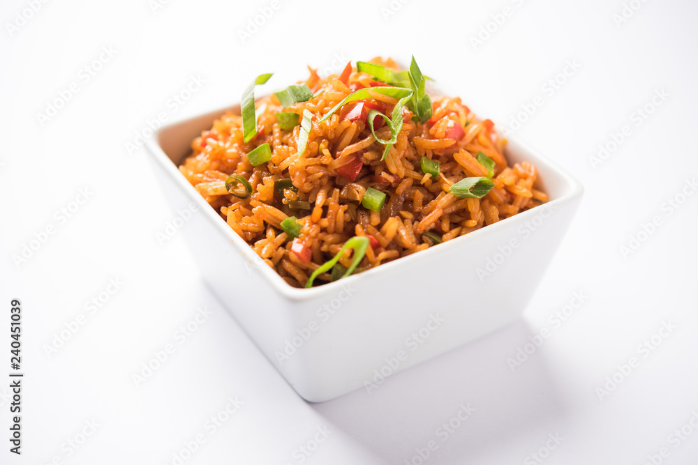Schezwan Fried Rice Masala is a popular indo-chinese food served in a plate or bowl with chopsticks. selective focus Schezwan Fried Rice Masala is a popular indo-chinese food served in a plate or bowl with chopsticks. selective focus