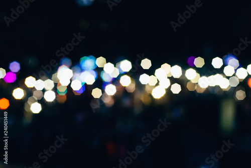 round blurred colored bokeh from lights on dark background © alexkoral