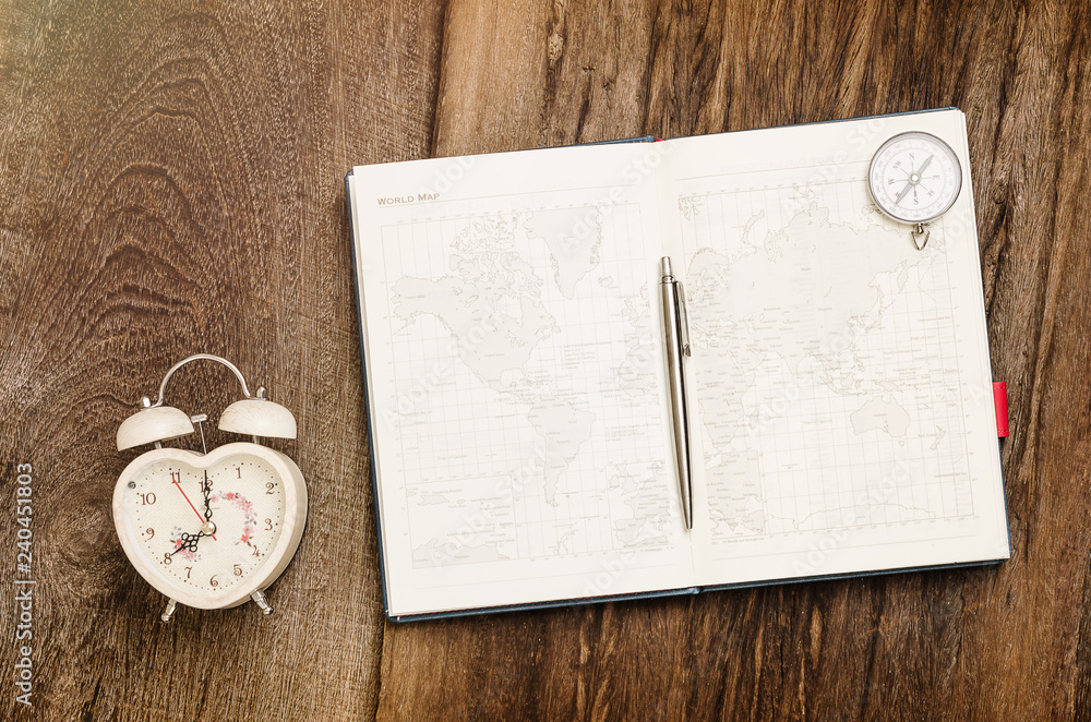 Clock pen book compass on grunge wood background illustrate to vacation holliday concept Clock pen book compass on grunge wood background illustrate to vacation holliday concept