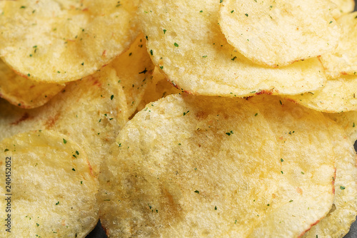 Potato chips sprinkled with greenery close up