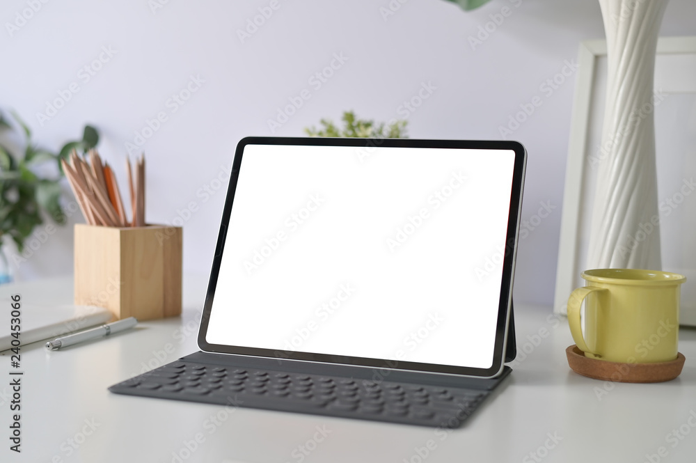 Fototapeta premium Workspace office table with mockup tablet and office supplies on office desk.