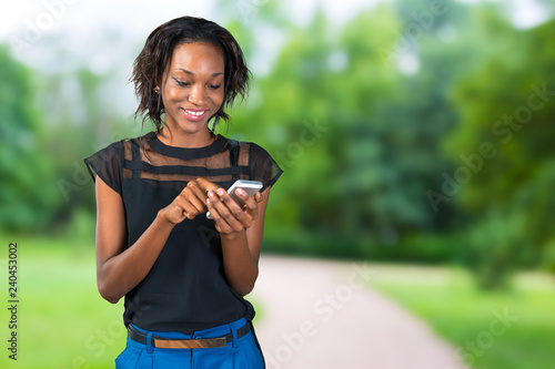 Casual businesswoman texting on phone