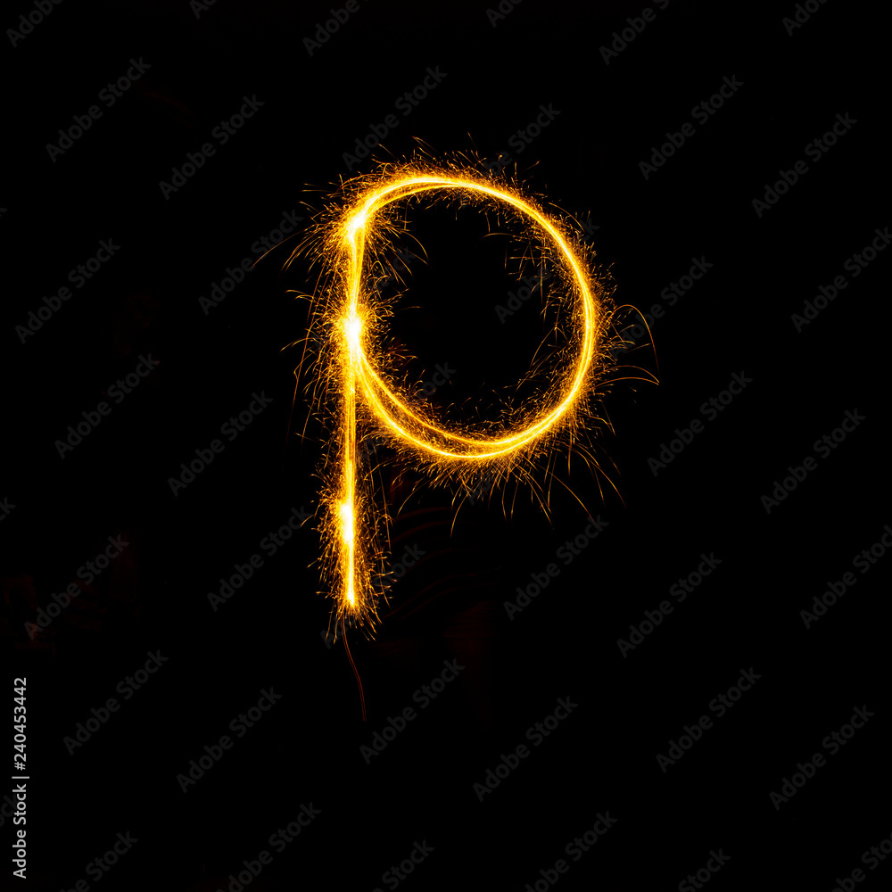 Alphabet sparklers on black background single letter