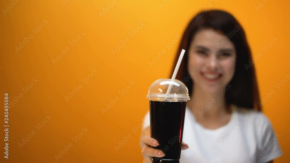 Happy girl showing diet soda to camera, low calorie drink, healthy lifestyle Happy girl showing diet soda to camera, low calorie drink, healthy lifestyle