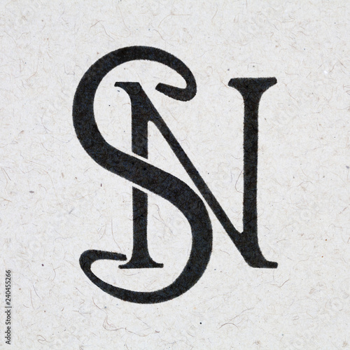 S N monogram, ink bleed on craft paper