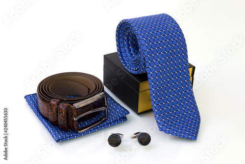 Foto Brown belt, blue tie with box and pocket square, pair of sapphire cuff links on white glassy surface