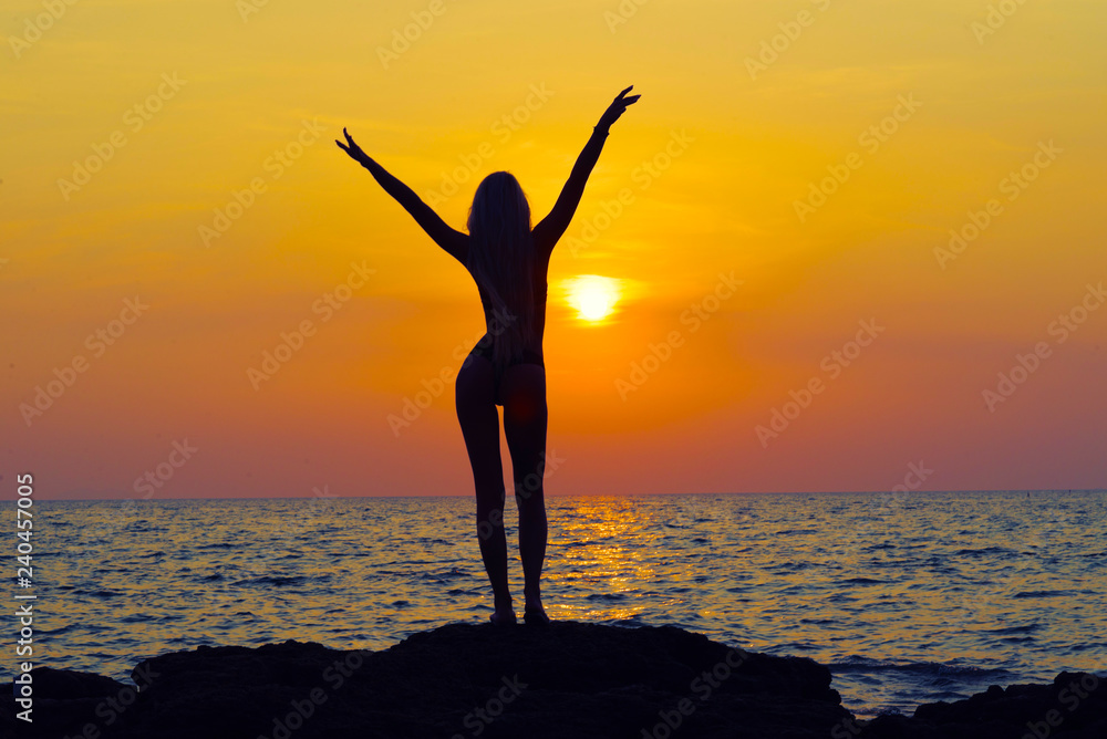 Young happy woman with raised hands