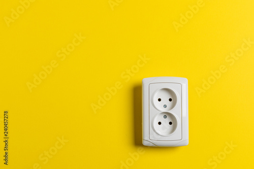 socket on yellow wall